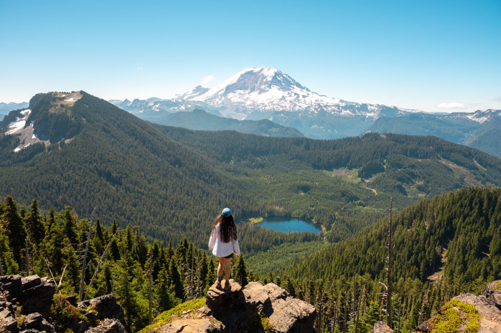 Hiker overlooking Mount Rainier and Coplay Lake from Summit Lake.